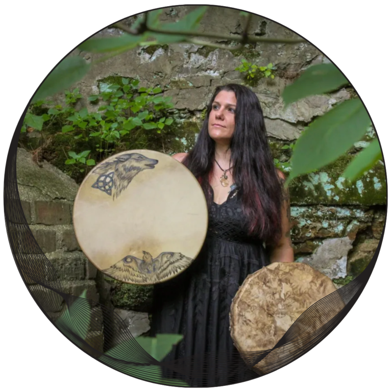 Tamara holding two shamanic drums.